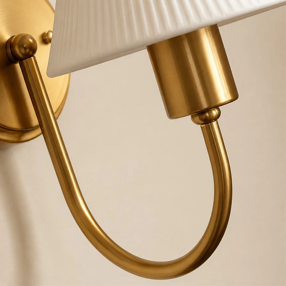 Antique brass curved metal arm detail